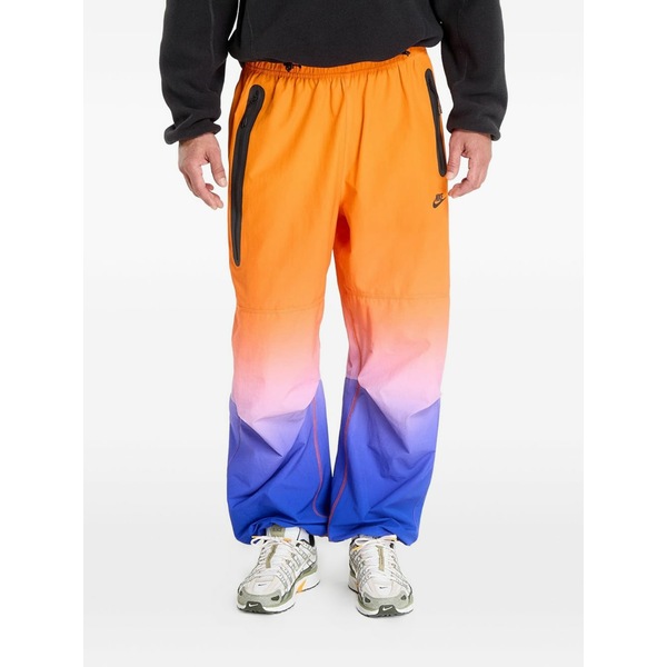 ナイキ メンズ 心地よいズボン下 ボトムス Woven track pants Orange
