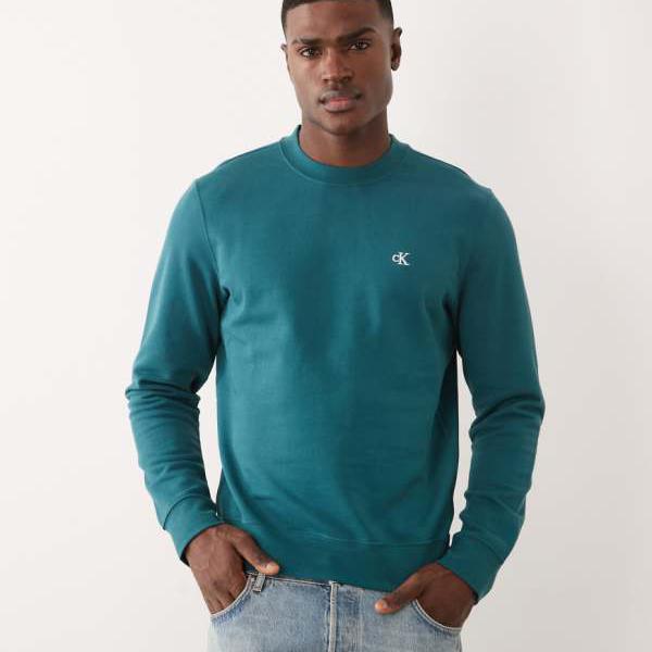 カルバンクラインジーンズ Calvin Klein Jeans カルバン・クライン・ジーンズのグラフィック・スウェットシャツ（ティールカラー） トップス レディース 亭主もち インポートブランド ごく小さい大きさから大層らしい大きさまで