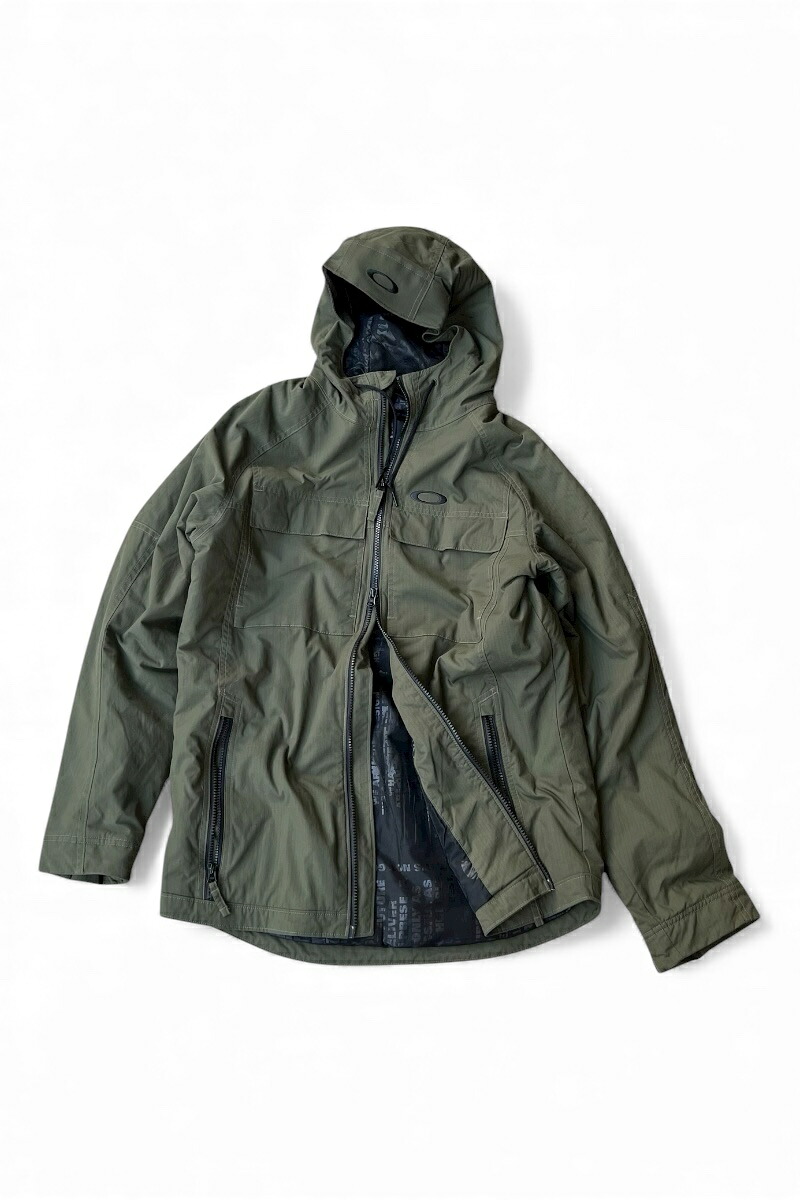 【中古】OAKLEY (オークリー) 15'S RIPSTOP NYLON ZIP HOODIE PUFF JACKET 15年 リップストップ ナイロン ジップ フーディ パフ ジャケット / OLIVE [SIZE: M USED]｜JULIUS NYC