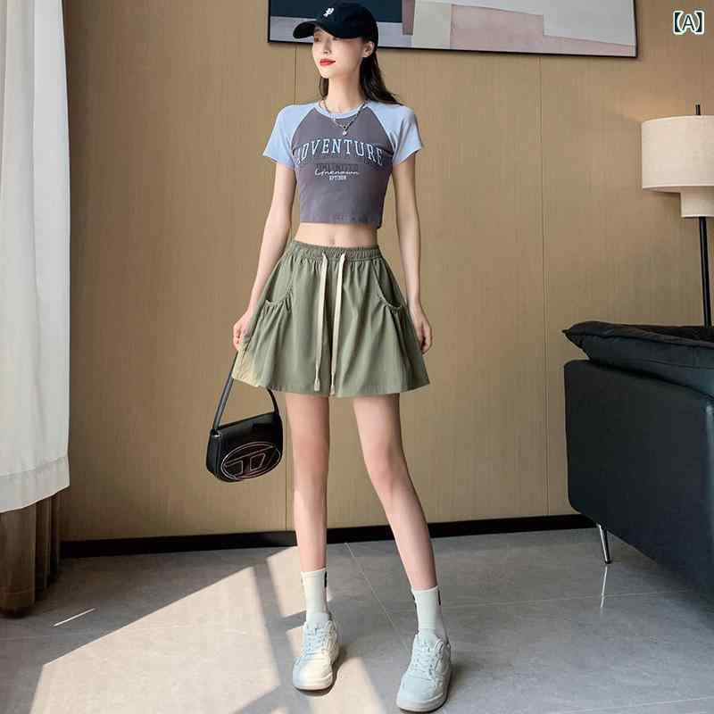 韓 系の 大衆の デザイン 感が 高くて、 腰を 緩めて、 カジュアルな半 ズボンの 女性の しわの 大きい ポケットが ゆったり して いて、 やせて います。