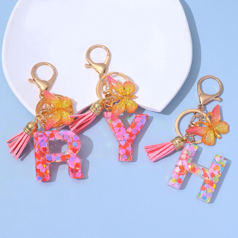 レディース キーホルダー 御徒面子惹きつける サクラ色 キラキラ レジン かしら文字 蝶柄 タッセル シャンデリヤ 吊り下げ 佩び物 愛くるしげ 日常使い走り 流行り物 個条x50