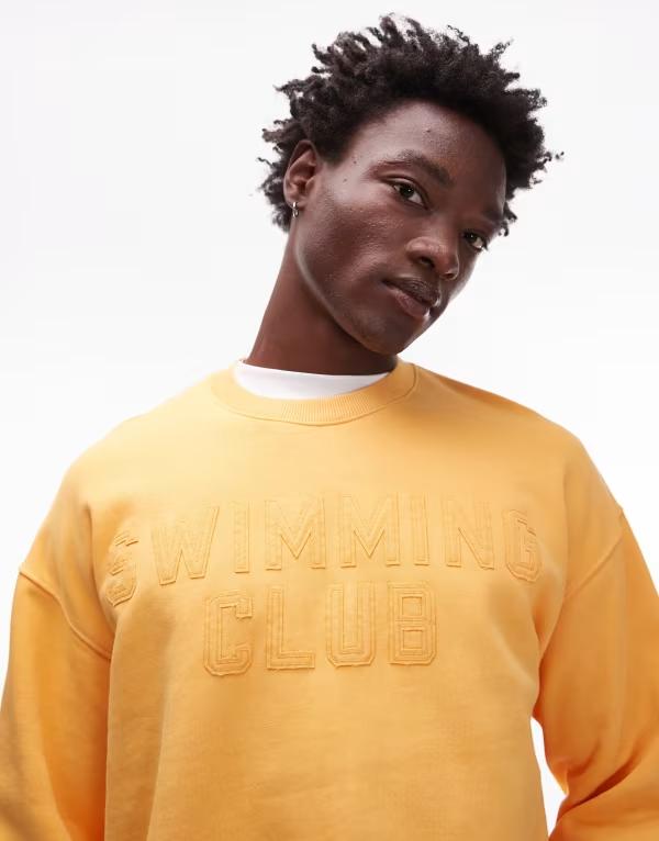 トップマン メンズ アウター パーカー・スウェット オーバーサイズフィット スウェット シャツ Topman oversized fit sweatshirt with swimming club embroidery in washed orange Washed orange オレンジ