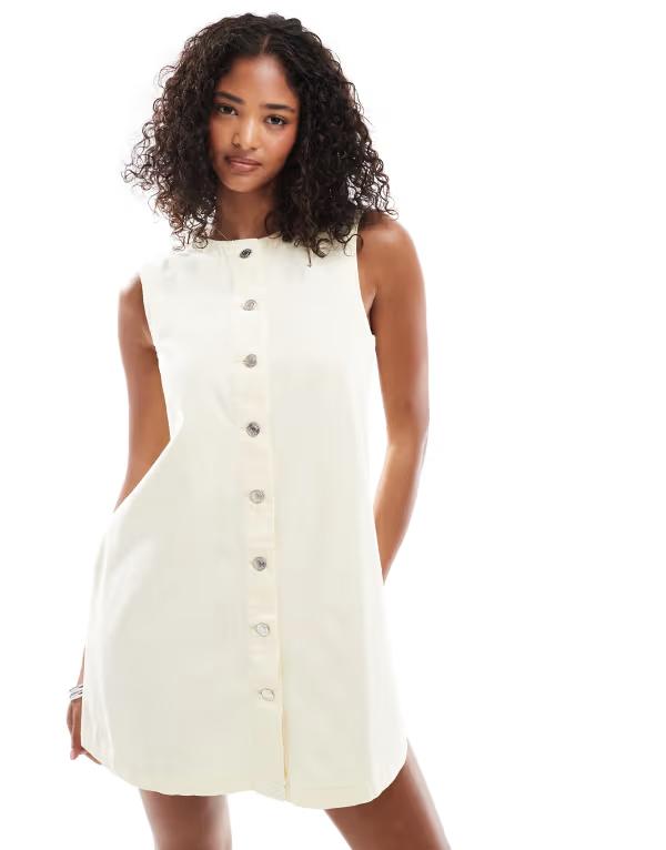 エイソス レディース トップス ワンピース ミニワンピース ミニ デニム ASOS DESIGN trapeze denim mini dress with button opening in pale yellow Buttermilk デニム