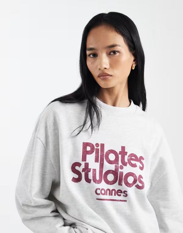 エイソス レディース アウター パーカー・スウェット シャツ グラフィック ASOS DESIGN oversized sweatshirt with pilatestudio graphic in ice heather Ice Marl マール｜ReVida 店