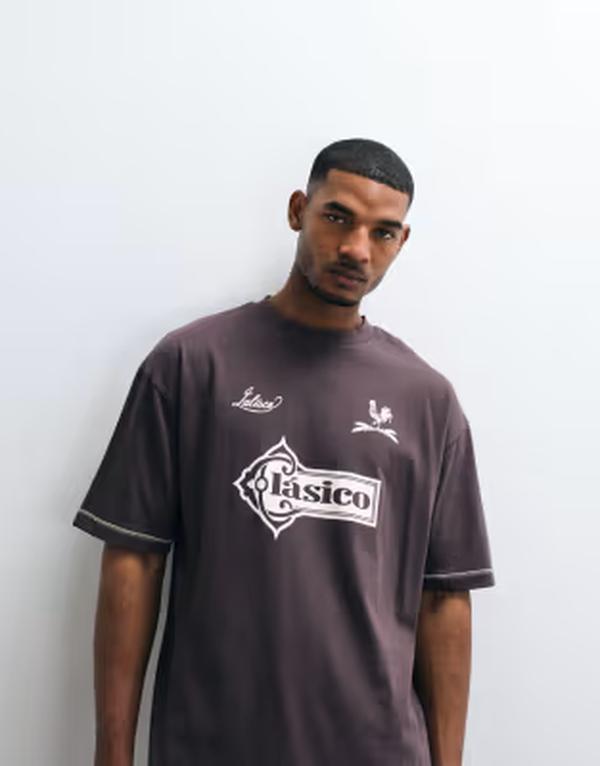 エイソス メンズ トップス ティーシャツ グラフィック ASOS DESIGN heavyweight oversized T-shirt with stitch detail and football graphic Seal brown 赤銅色