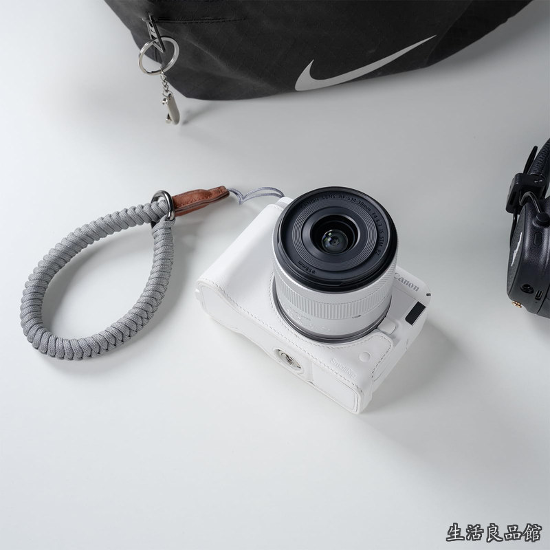 【貨物輸送無料】Canonに相応うR50 V用カメラレザーハーフケースキット ハーフレザーケースと編み込みリストストラップ付き添い人 本革原料品 持ち運びやすく保護すること力 （白いこと） 5431