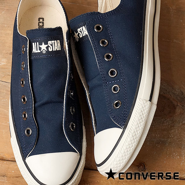 navy blue low cut converse