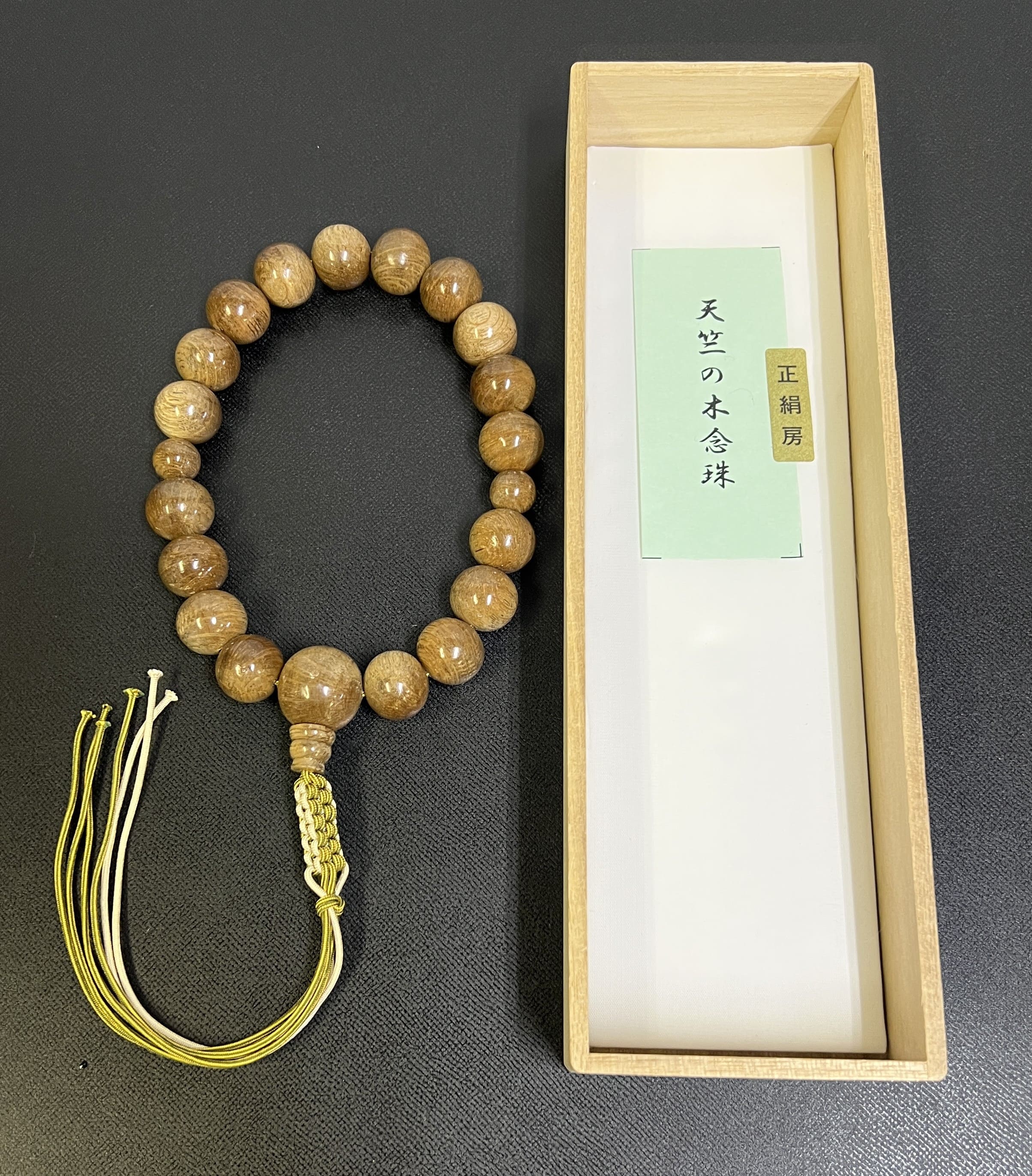 天竺（18玉）の木数珠は、数ある無憂樹の中でも「最御前上等品」とされ、お釈迦様が無憂樹の下で涅槃を開いたという謂われ因縁から、人並み外れたに止ん事無い道徳的美点がある原料品として和氏の璧されています。吊りひも房・成人男性用。ツイル織数珠袋を、三色の中からお後ばらいします。