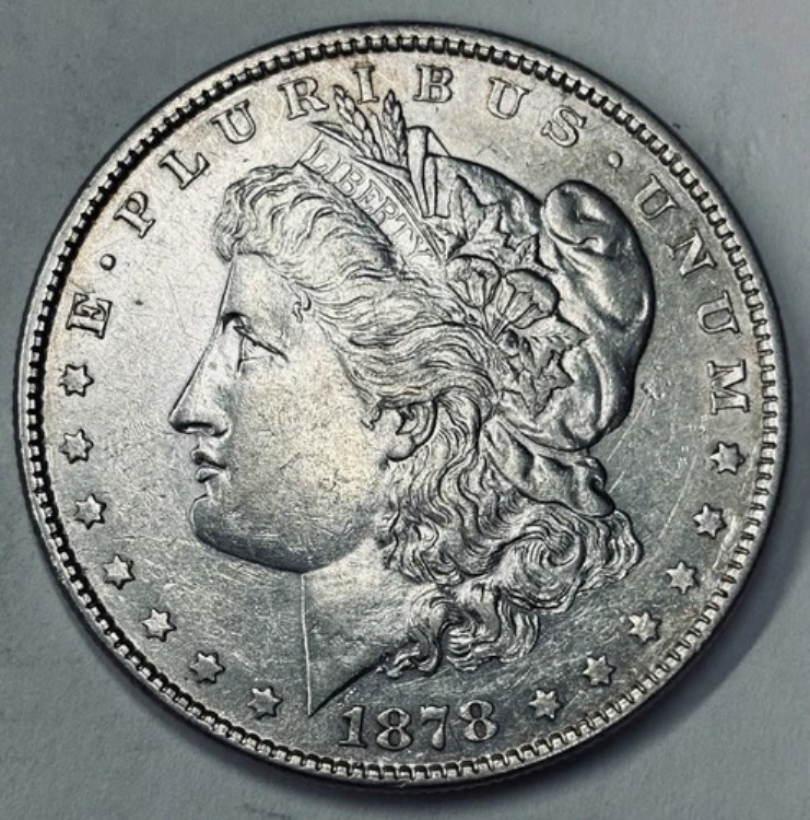 1878 年モルガン銀貨 (Rev. 79)、7 TF、AU+、フィラデルフィア造幣局。